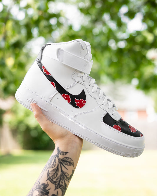 Showcase your love for anime with these custom Nike Air Force 1 sneakers. Featuring a striking design with black panels and red cloud accents, these one-of-a-kind shoes are hand-painted for fans who appreciate unique, art-inspired footwear. Elevate your sneaker collection with this bold, artistic statement piece.