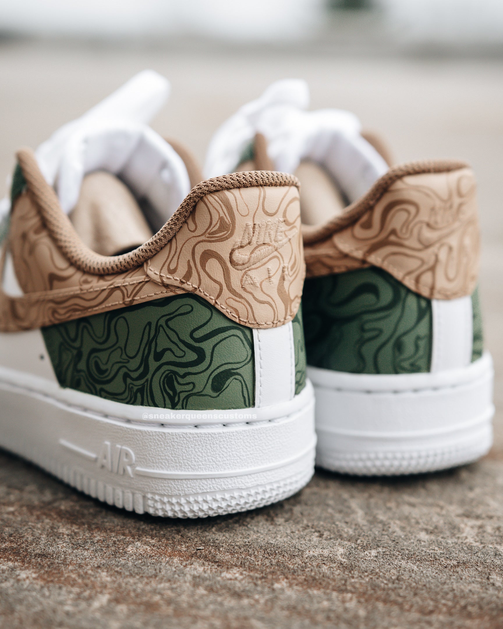 Custom Nike Air Force 1 sneakers featuring a unique design with green and tan topographic patterns on white leather, inspired by nature’s landscapes.